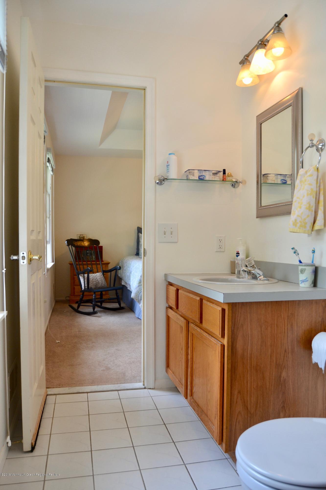 3087 Ridgeway Boulevard Manchester Township, NJ 08759 - Photo 29 of 30 a bathroom with a sink a toilet and mirror