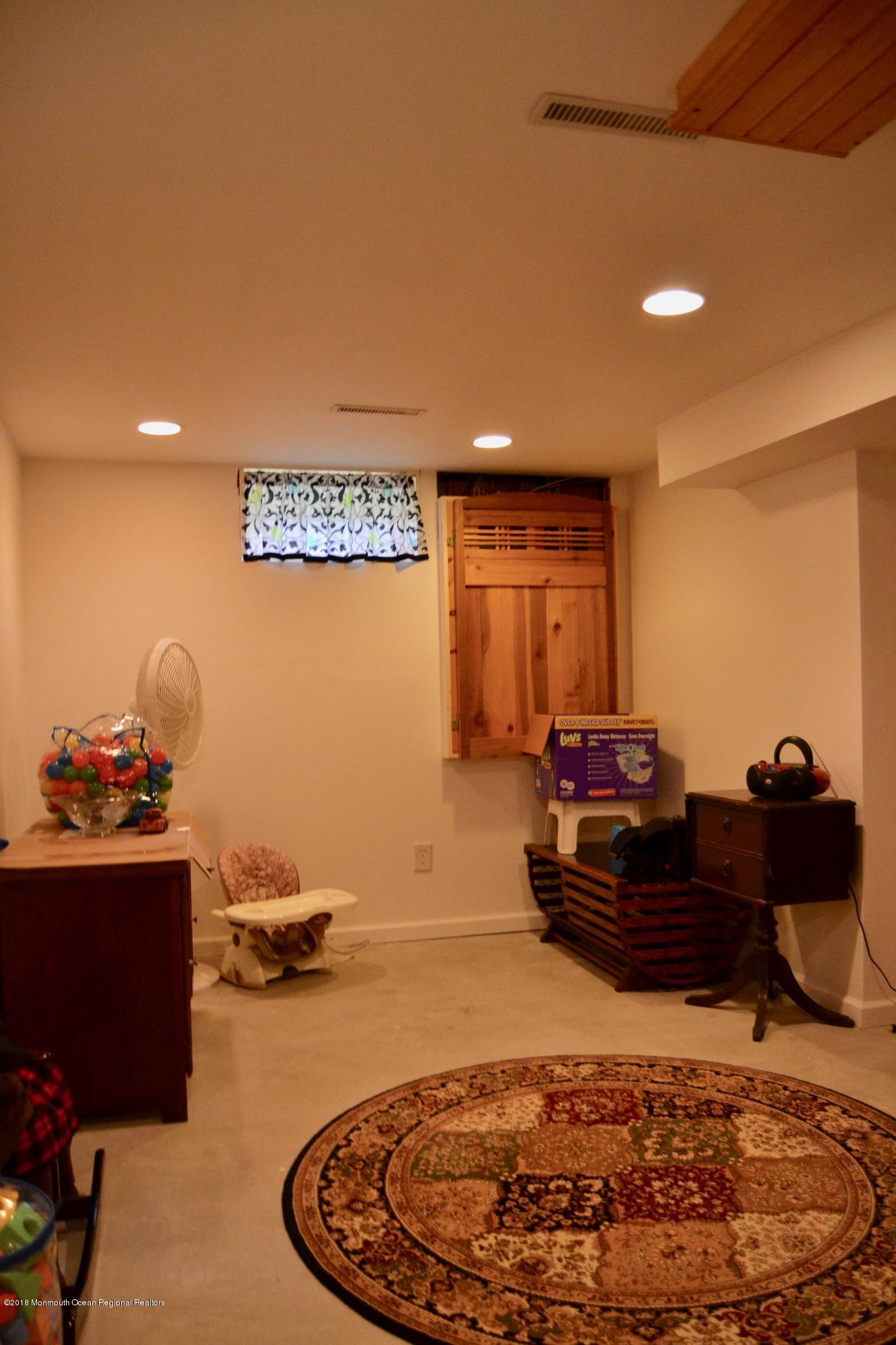3087 Ridgeway Boulevard Manchester Township, NJ 08759 - Photo 30 of 30 a living room with a couch and a dresser with wooden floor