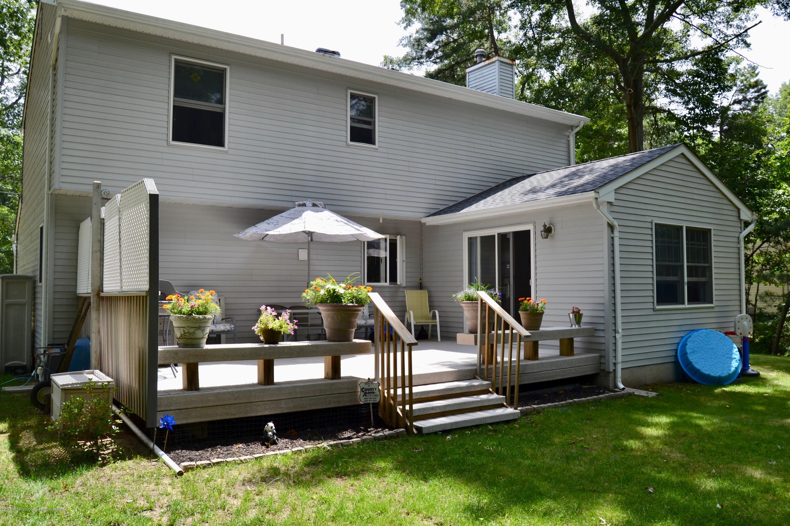 3087 Ridgeway Boulevard Manchester Township, NJ 08759 - Photo 3 of 30 a front view of a house with a garden and outdoor seating