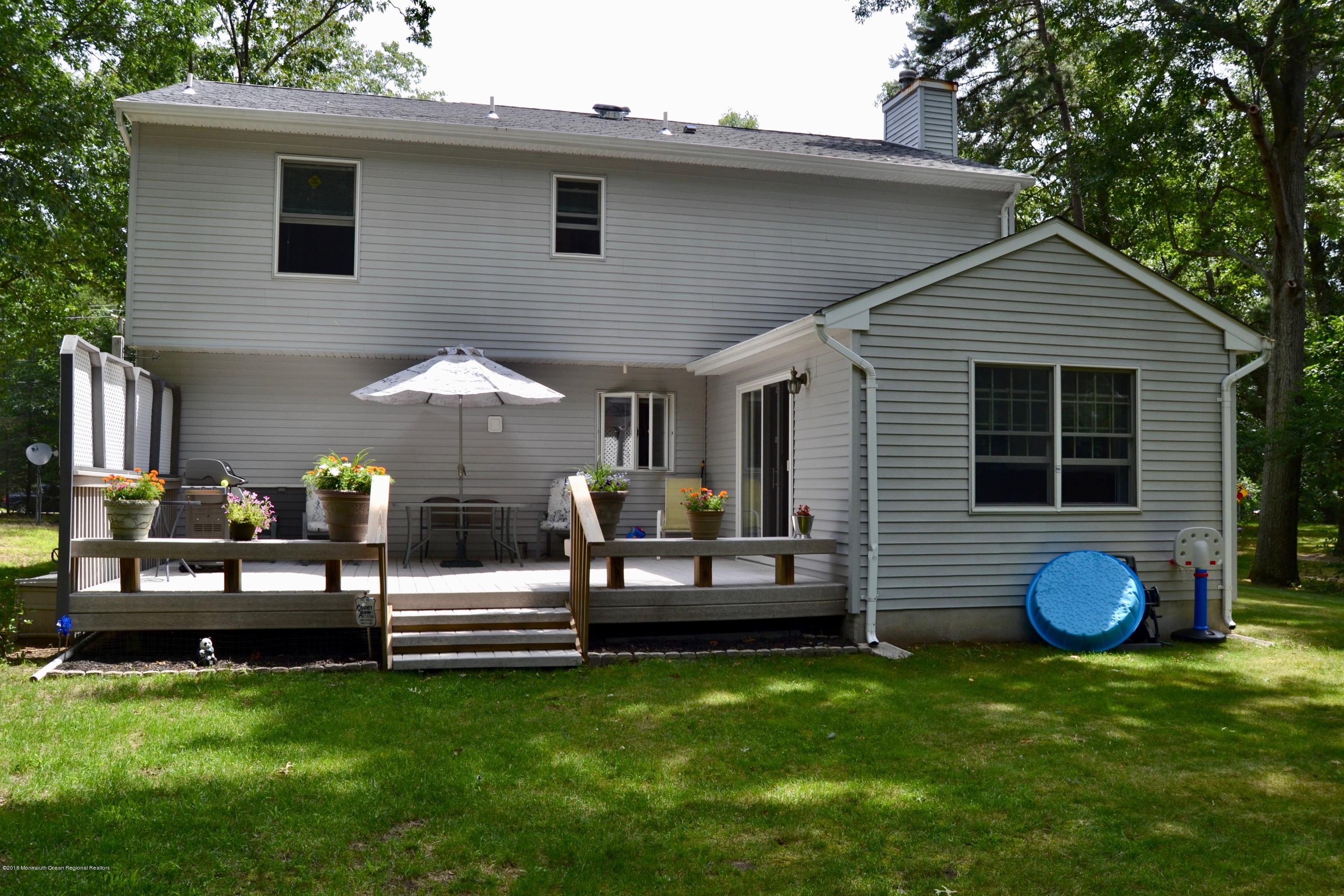 3087 Ridgeway Boulevard Manchester Township, NJ 08759 - Photo 4 of 30 a front view of a house with a garden