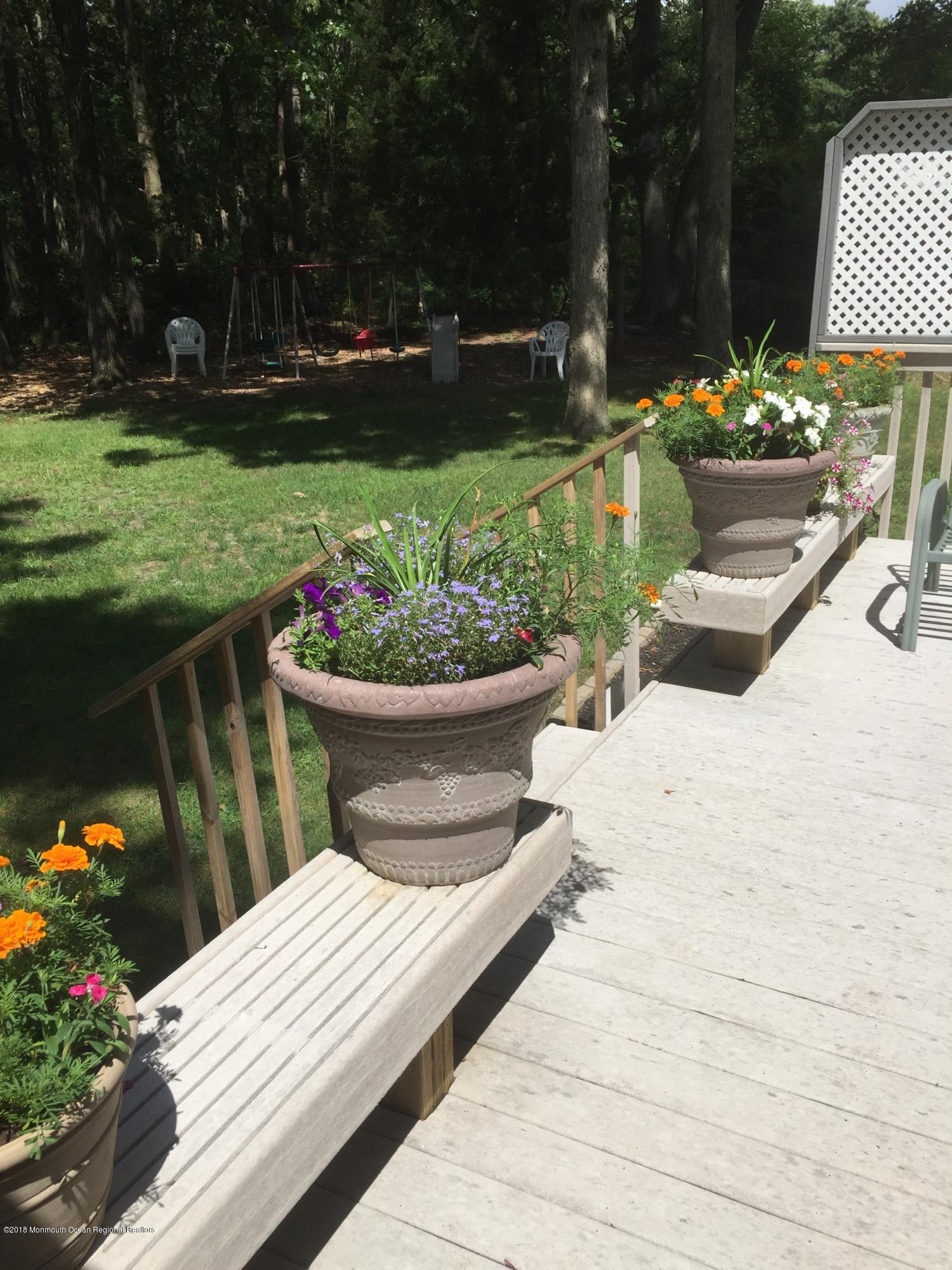 3087 Ridgeway Boulevard Manchester Township, NJ 08759 - Photo 6 of 30 a view of a garden with flowers and trees