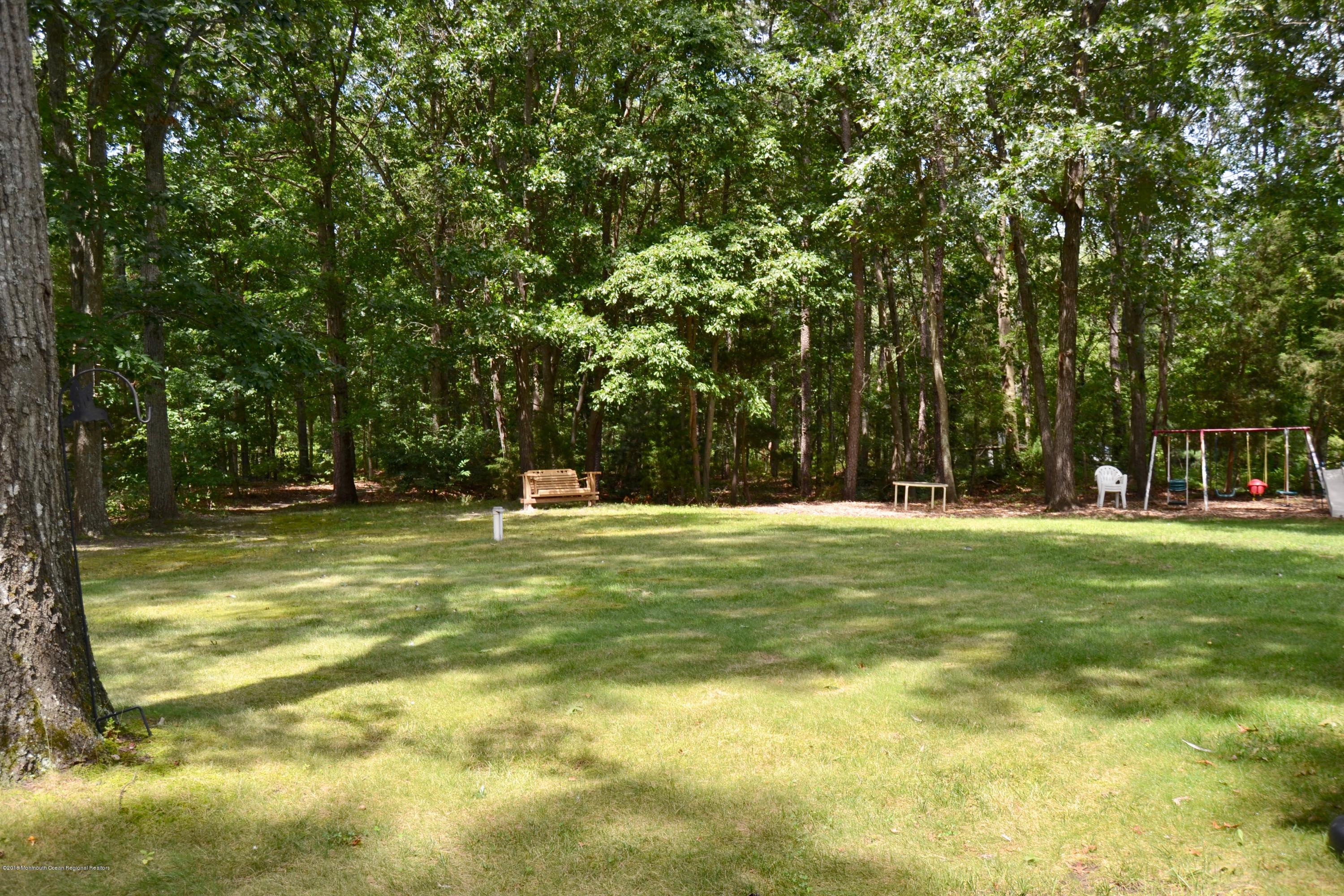 3087 Ridgeway Boulevard Manchester Township, NJ 08759 - Photo 9 of 30 a view of a trees in a yard