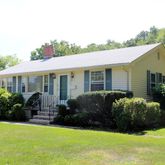 a view of a house with backyard and plants
