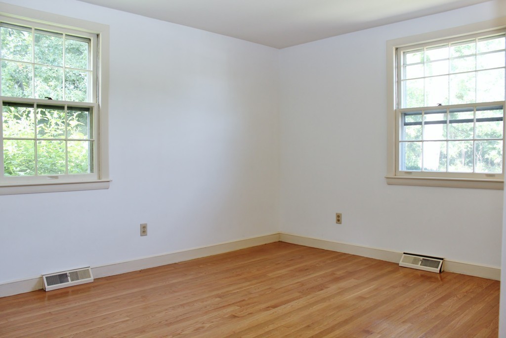 49 Rockland Street Hingham, MA 02043 - Photo 13 of 28 an empty room with wooden floor and windows