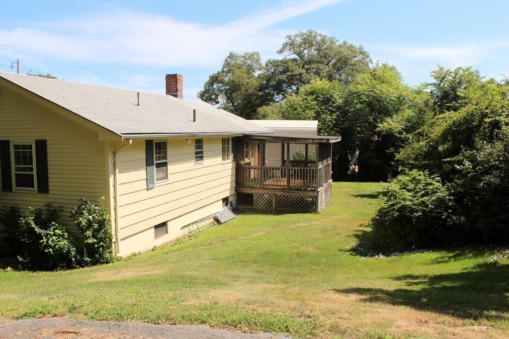 49 Rockland Street Hingham, MA 02043 - Photo 21 of 28 a view of a white house next to a yard with big trees
