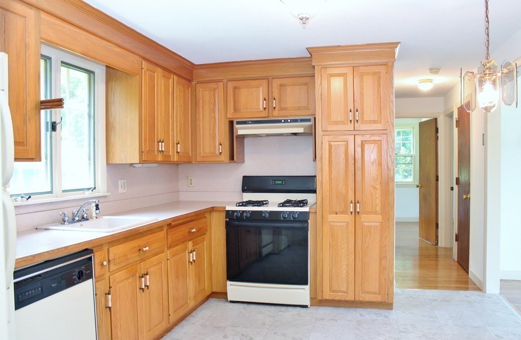 49 Rockland Street Hingham, MA 02043 - Photo 5 of 28 a kitchen with stainless steel appliances granite countertop a stove and a refrigerator