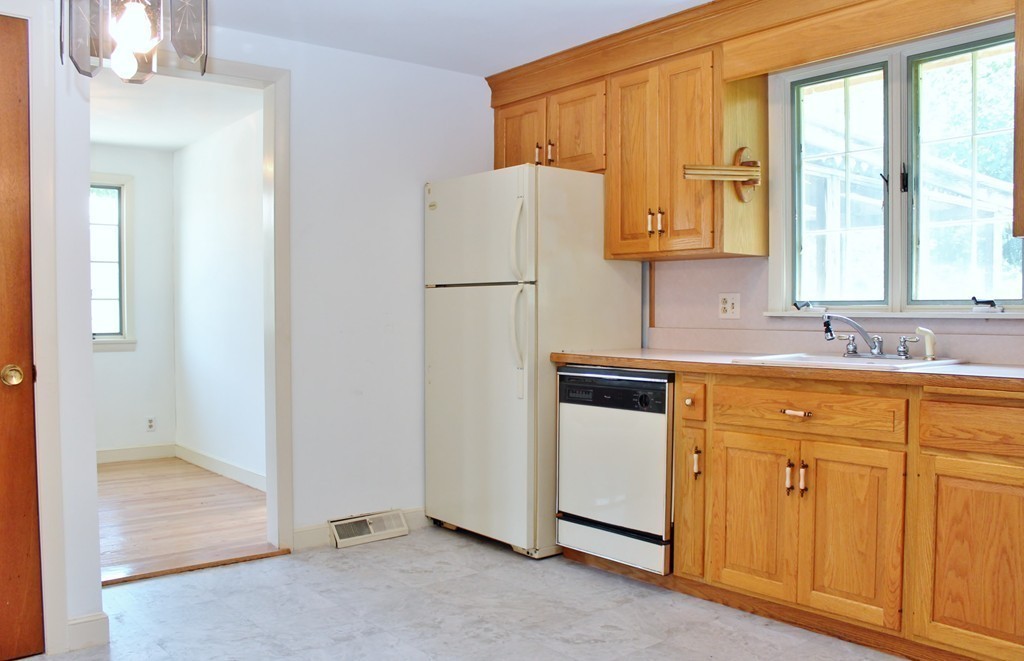 49 Rockland Street Hingham, MA 02043 - Photo 6 of 28 a white refrigerator freezer sitting inside of a kitchen