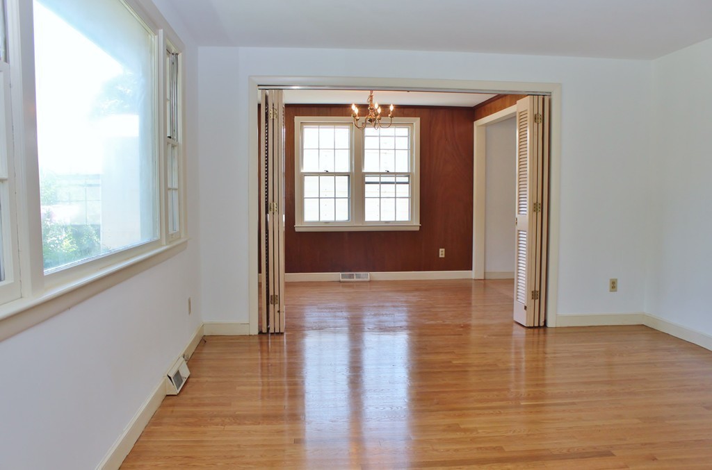 49 Rockland Street Hingham, MA 02043 - Photo 9 of 28 a view of an empty room with wooden floor and a window