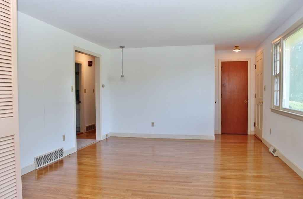 49 Rockland Street Hingham, MA 02043 - Photo 10 of 28 an empty room with wooden floor and windows