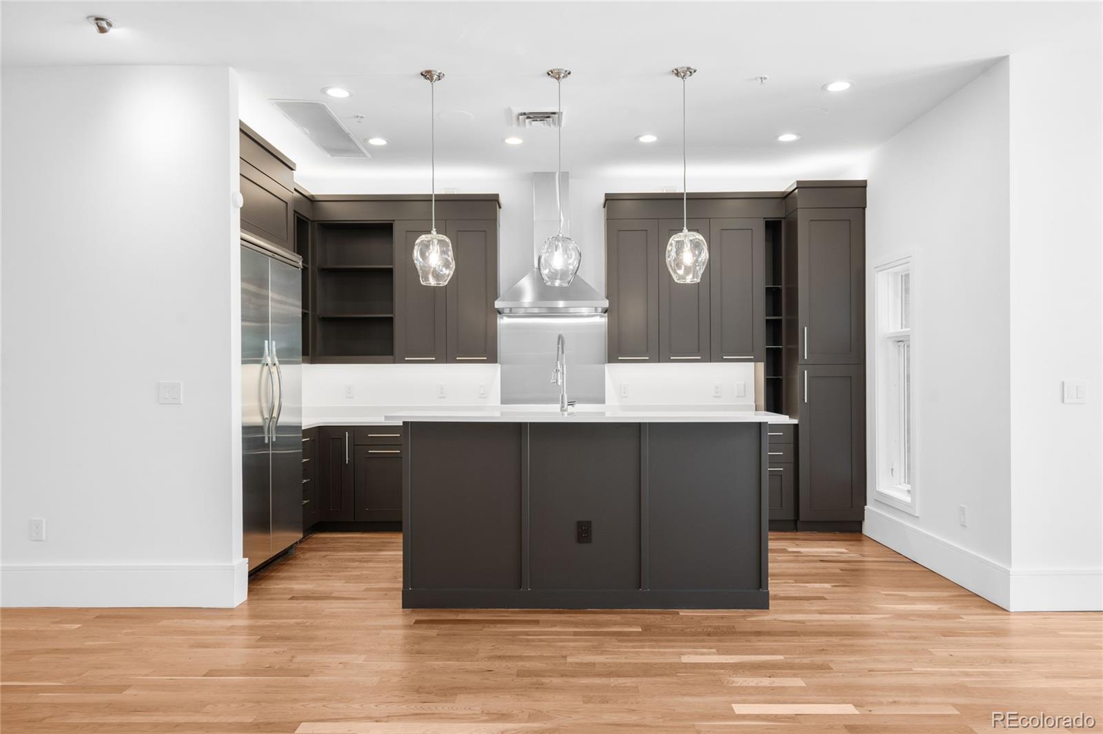 2133 18th Street Denver, CO 80202 - Photo 11 of 46 a bathroom with a sink vanity and a mirror