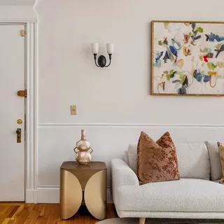 a living room with furniture and a potted plant