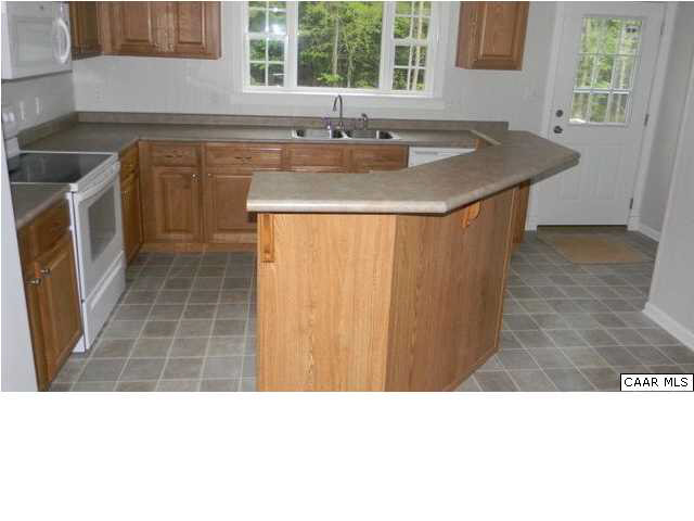 228 Knights Road Buckingham, VA 23921 - Photo 5 of 12 a kitchen with a sink stove and cabinets