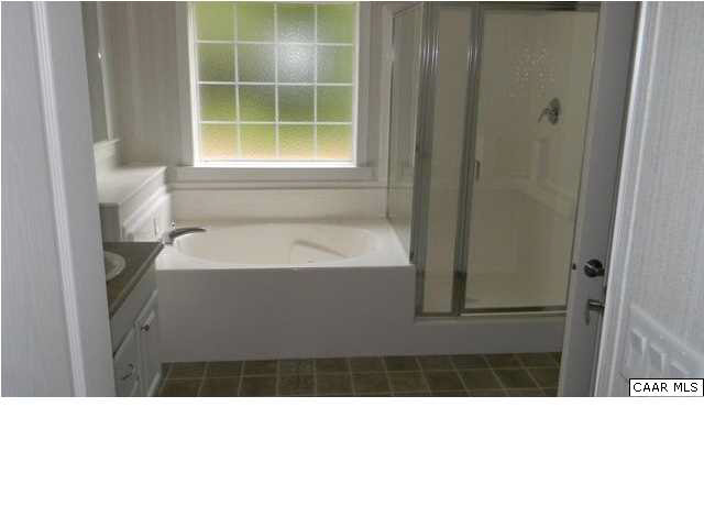 228 Knights Road Buckingham, VA 23921 - Photo 7 of 12 a bathroom with a tub sink and a mirror