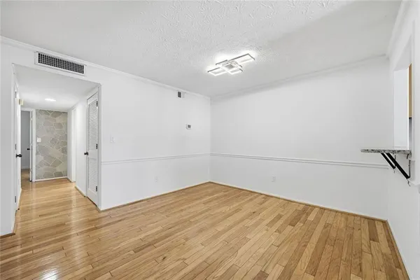 a view of a room with wooden floor