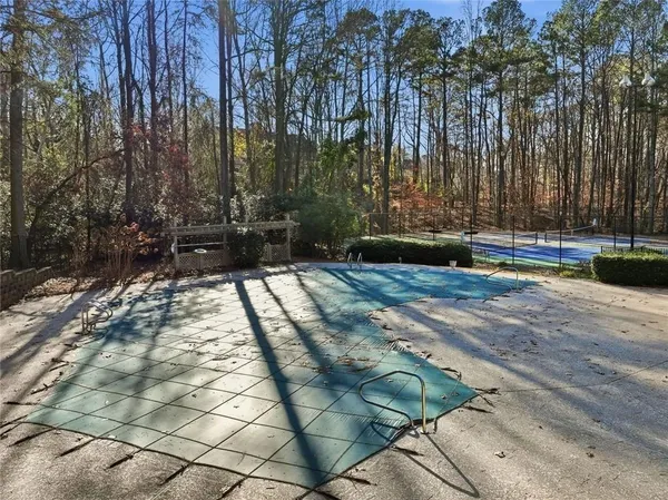 a view of a backyard with swimming pool