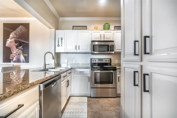 a kitchen with granite countertop cabinets and steel stainless steel appliances
