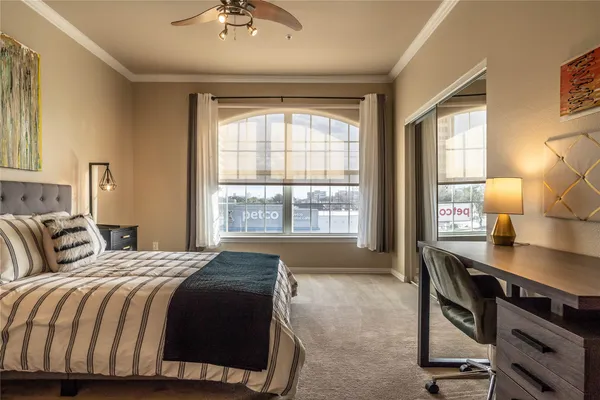 a spacious bedroom with a bed and a table in it
