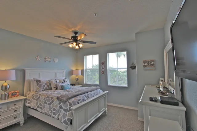 a bedroom with a large bed and a window