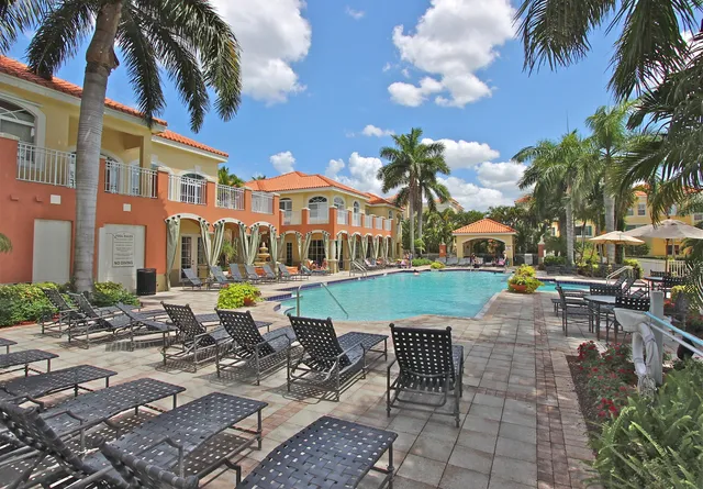 a front view of a building with garden and seating area