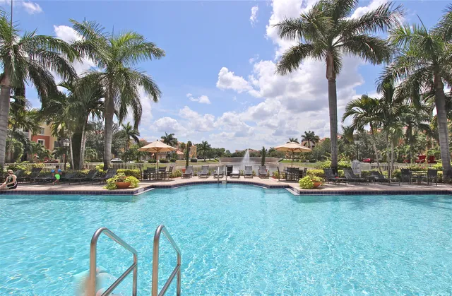 a view of a swimming pool with a table and chairs