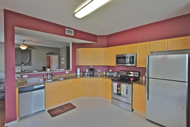 a kitchen with refrigerator and cabinets