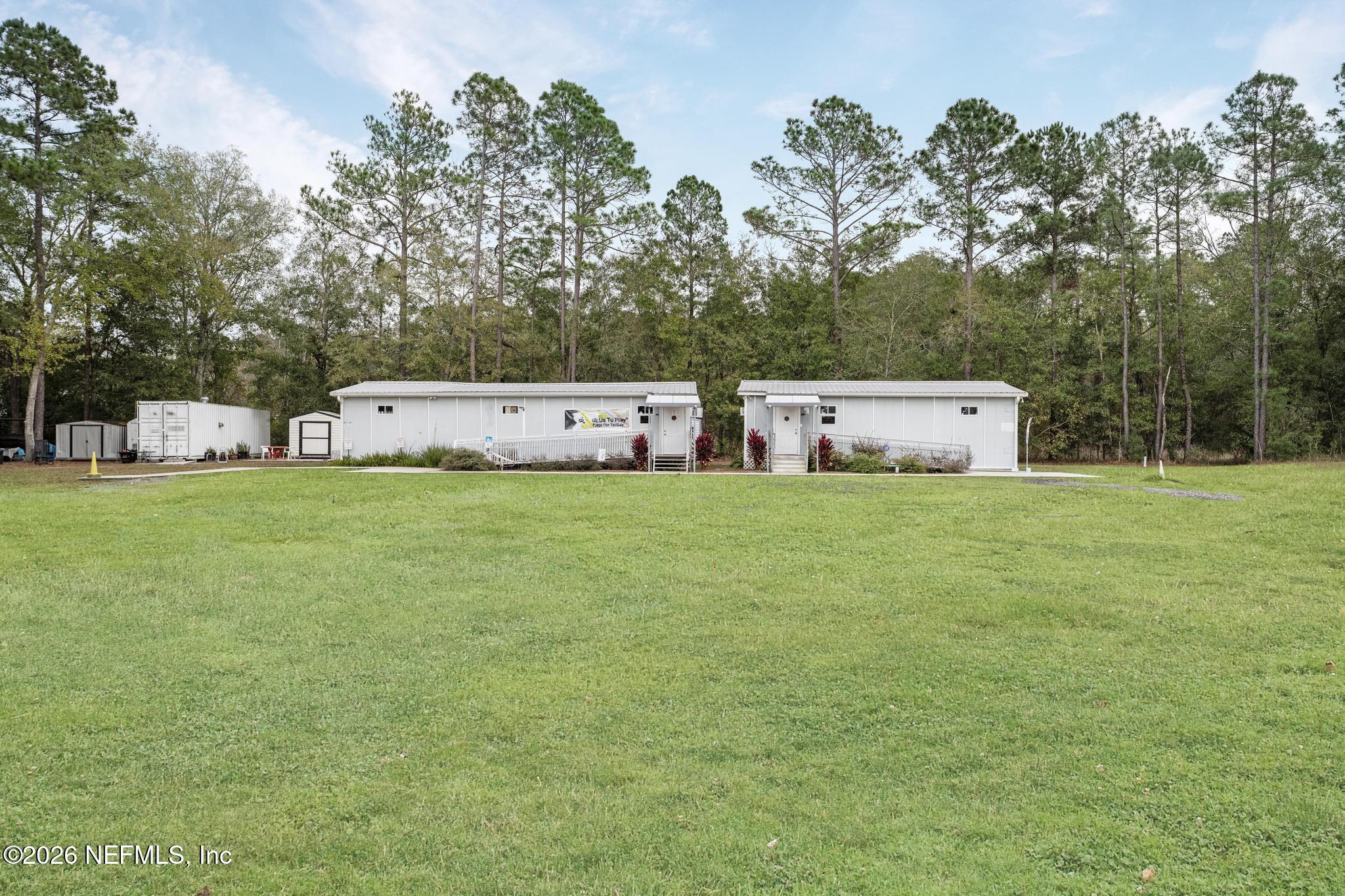 6647 Jammes Road Jacksonville, FL 32244 - Photo 12 of 17 a view of a big yard with large trees
