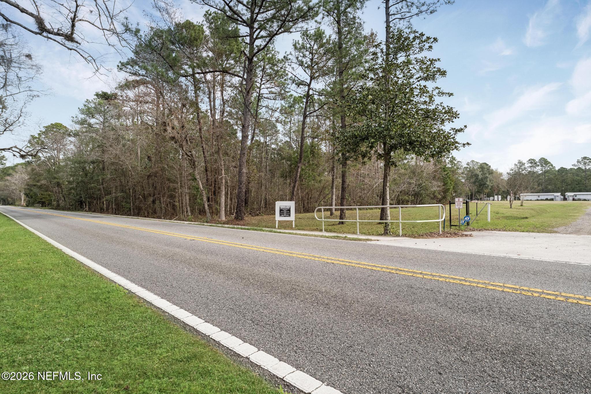 6647 Jammes Road Jacksonville, FL 32244 - Photo 17 of 17 a view of a house with a big yard and large trees