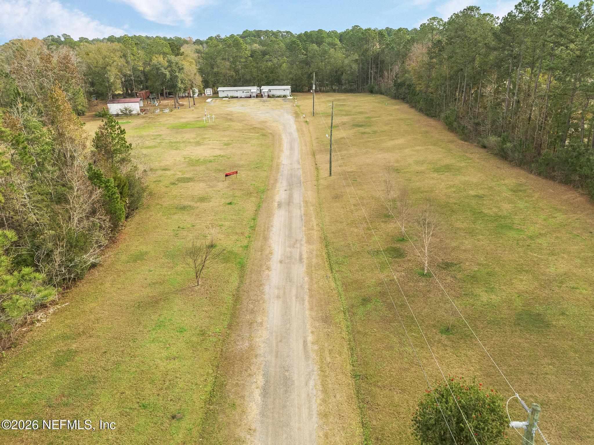 6647 Jammes Road Jacksonville, FL 32244 - Photo 5 of 17 a swimming pool with trees in the background