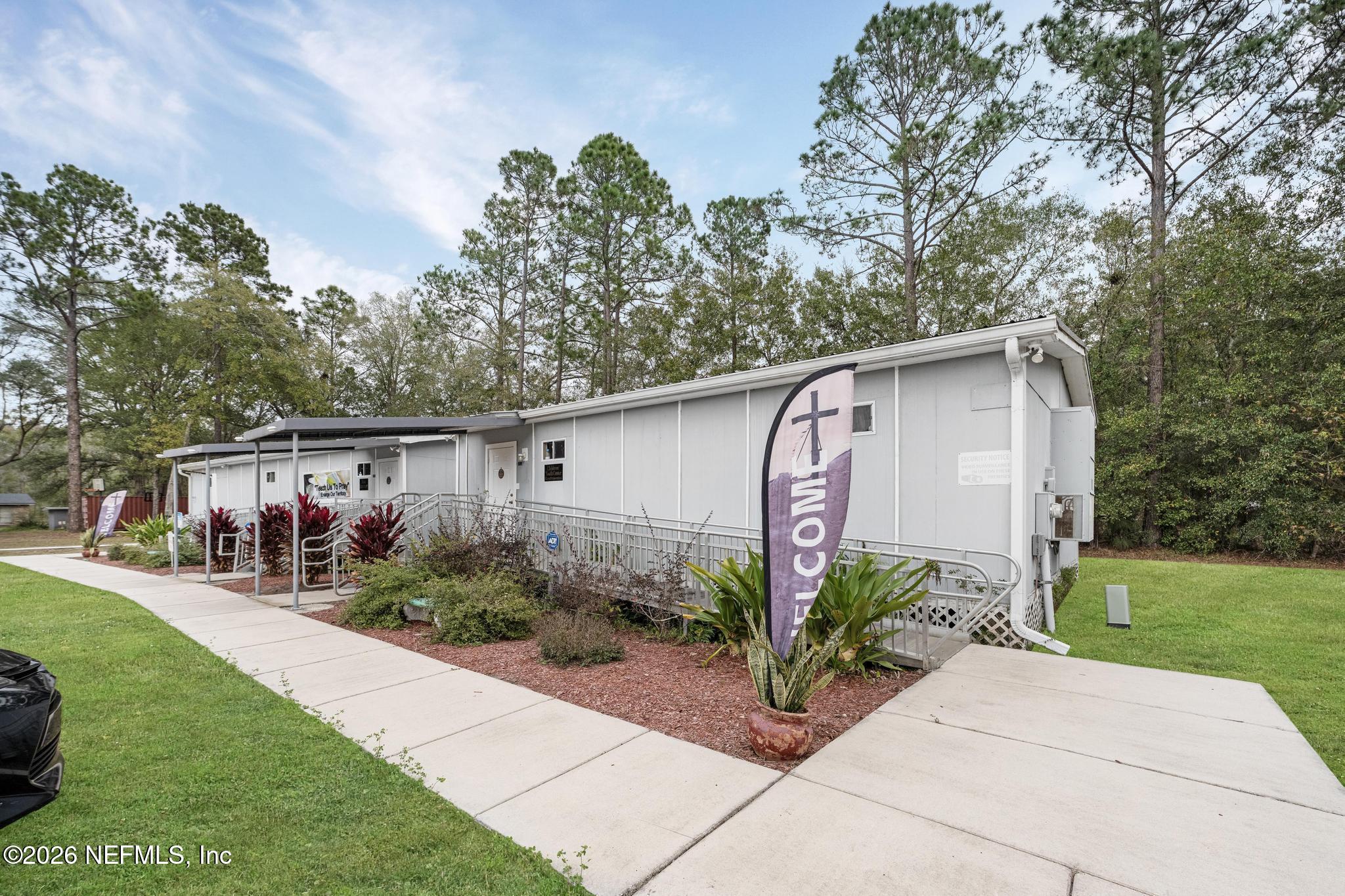 6647 Jammes Road Jacksonville, FL 32244 - Photo 10 of 17 a front view of a house with garden