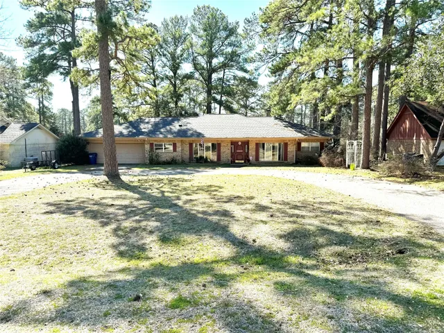 a view of a house with a yard and tree