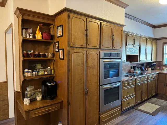 a kitchen with stainless steel appliances granite countertop a refrigerator and a stove