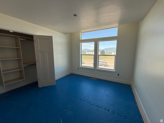 3308 South 1000 West Logan, UT 84321 - Photo 12 of 14 Room featuring a large window array, built-in shelving, a recessed light, and a paneled door