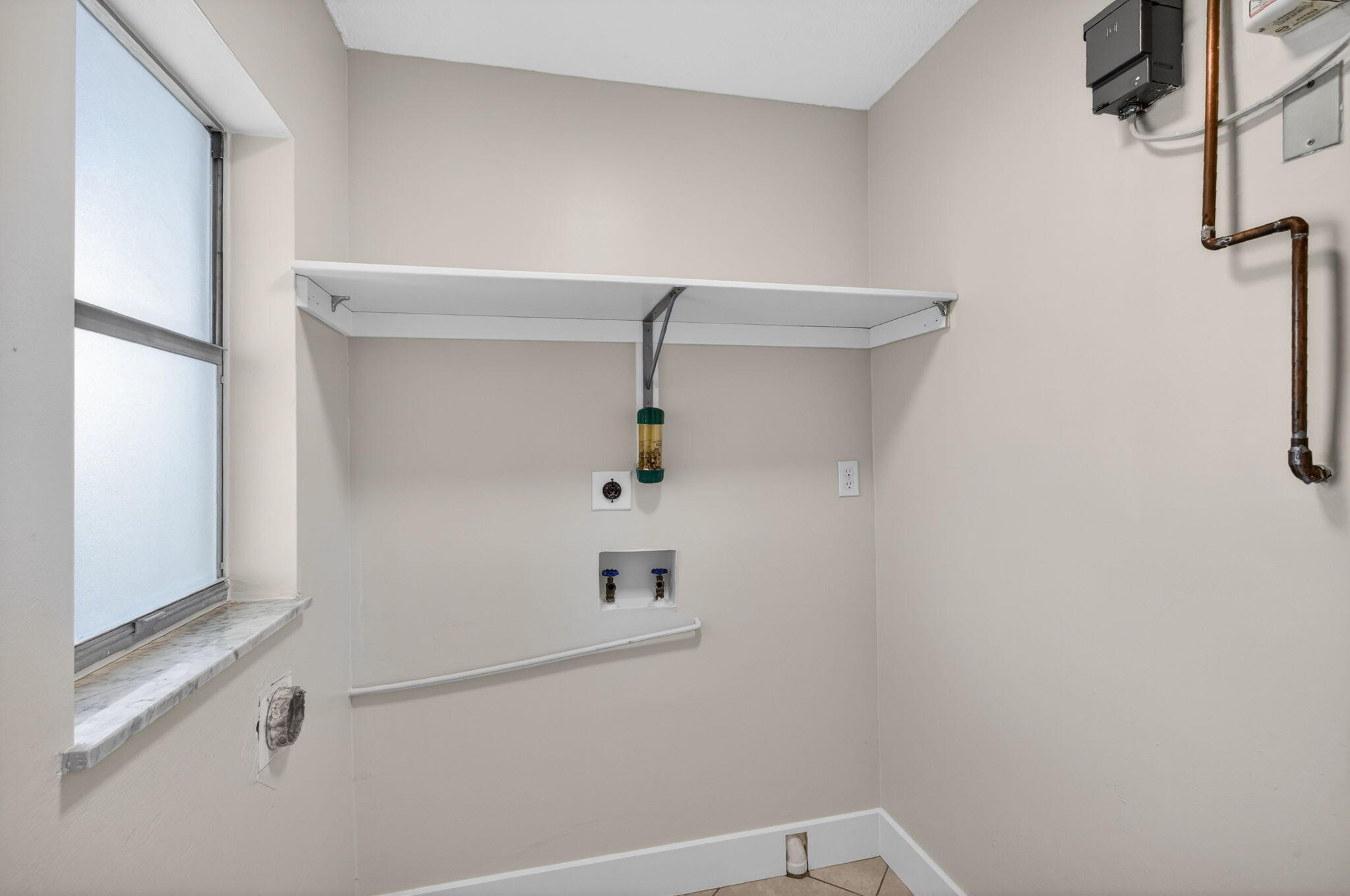 8695 Southeast Hobe Ridge Avenue Hobe Sound, FL 33455 - Photo 11 of 29 a view of storage and utility room with racks on the wall