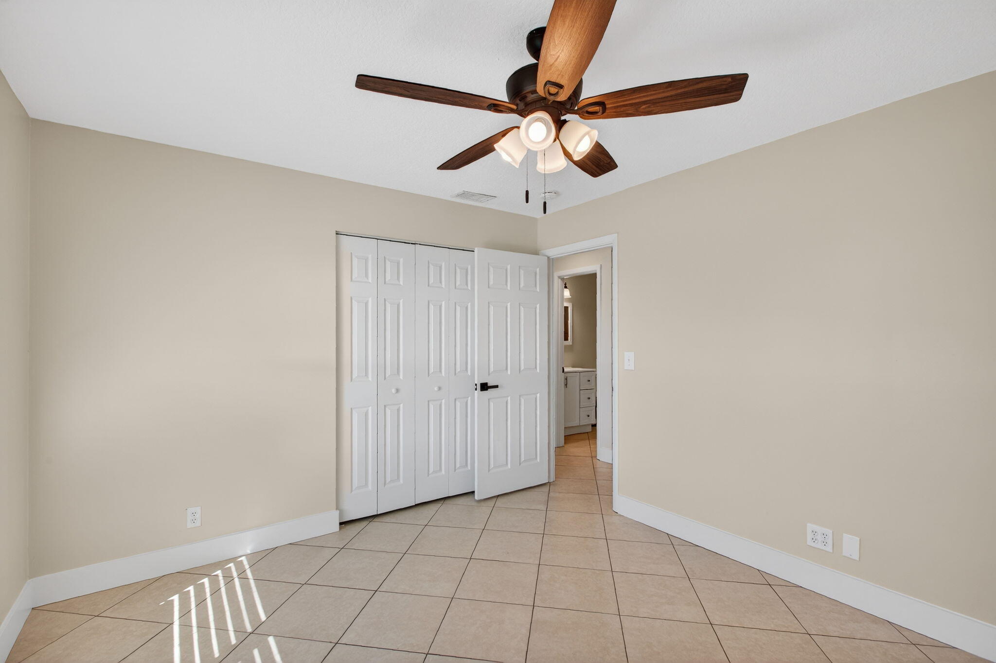8695 Southeast Hobe Ridge Avenue Hobe Sound, FL 33455 - Photo 21 of 29 a view of an empty room and chandelier fan