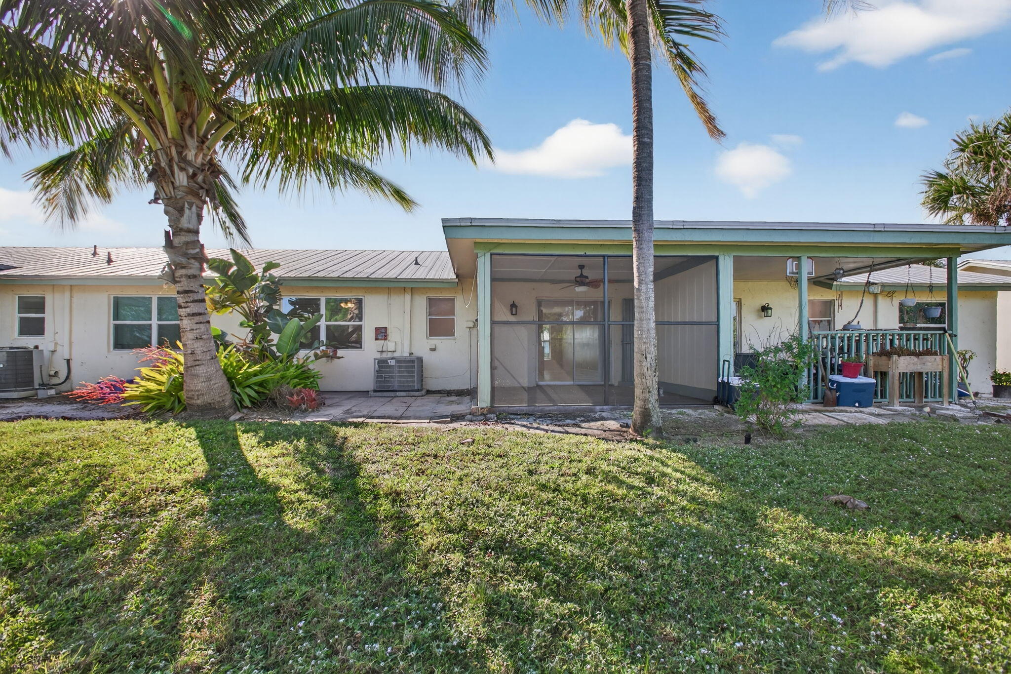 8695 Southeast Hobe Ridge Avenue Hobe Sound, FL 33455 - Photo 27 of 29 front view of a house with a big yard and potted plants
