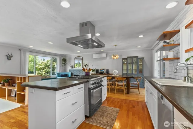 a kitchen with stainless steel appliances granite countertop a sink and stove