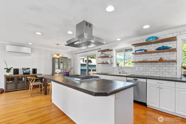 a large kitchen with stainless steel appliances granite countertop a sink counter space and cabinets