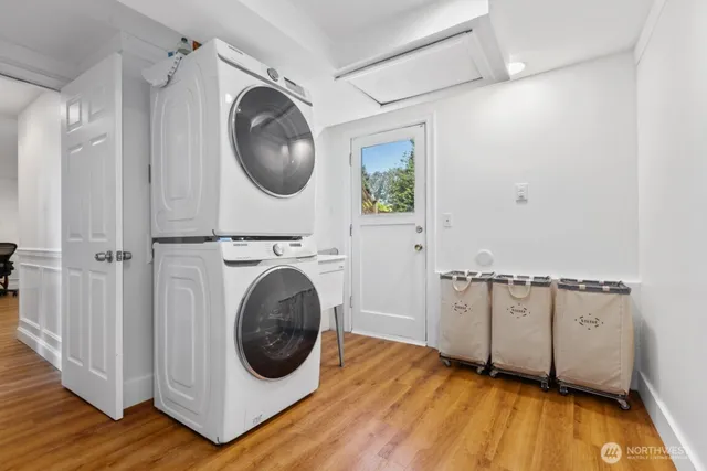 a patio with wooden floor table and chairs