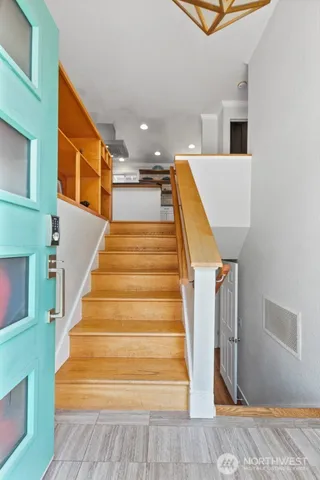 a view of entryway and hall with wooden floor