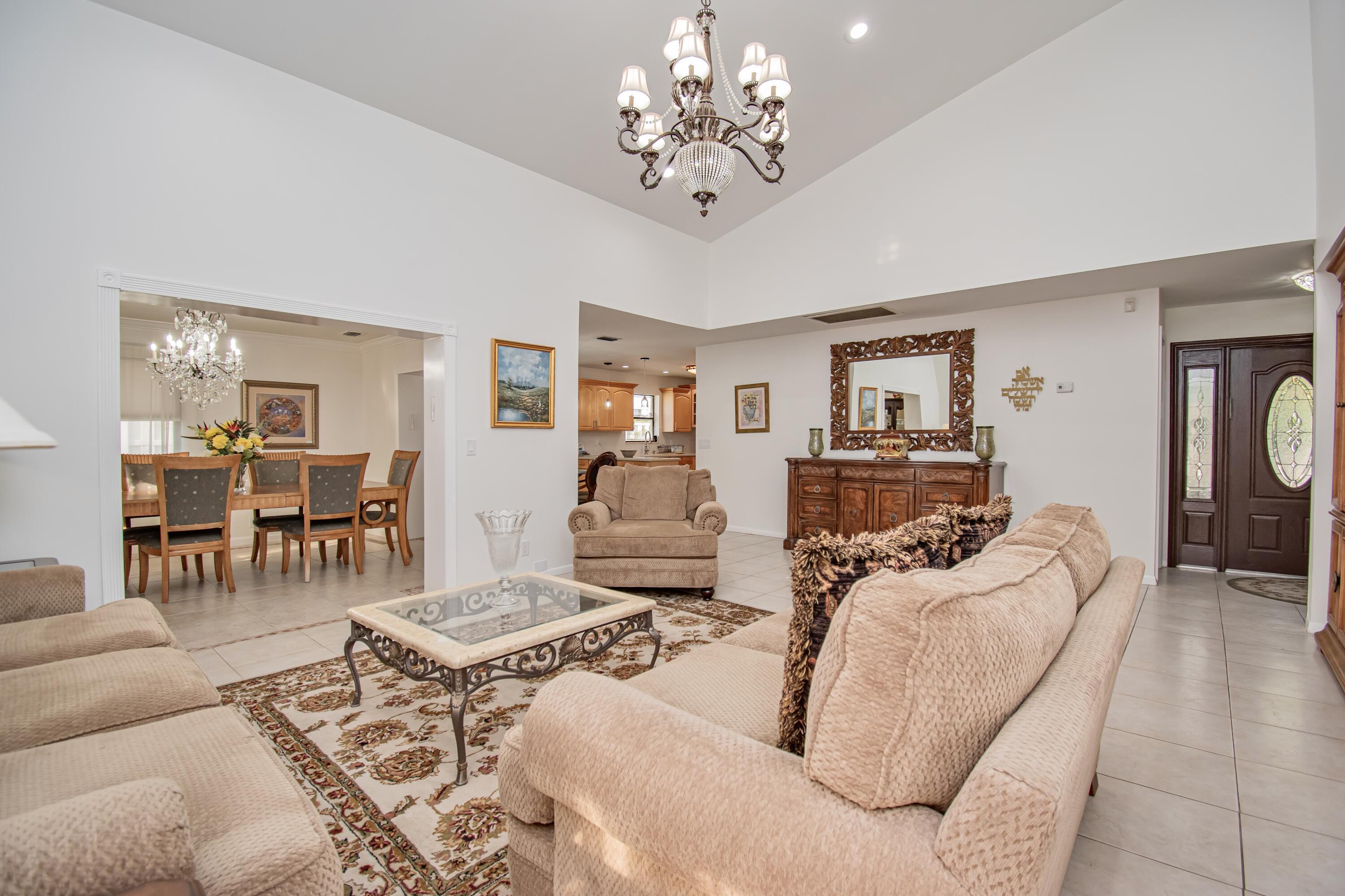 7838 Cypress Crescent Boca Raton, FL 33433 - Photo 5 of 24 a living room with furniture and a chandelier