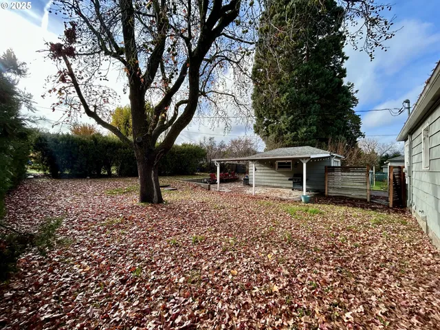 a backyard of a house with table and chairs