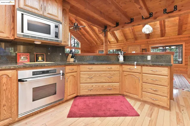 a view of a living room and kitchen floor to ceiling window with kitchen view