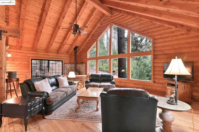 a living room with furniture and a floor to ceiling window