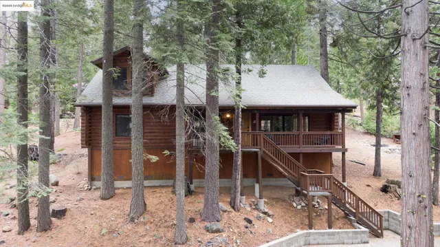 a living room with furniture a fireplace and a floor to ceiling window