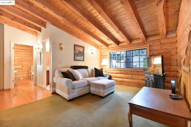 a view of a patio with couches table and chairs with wooden floor and fence