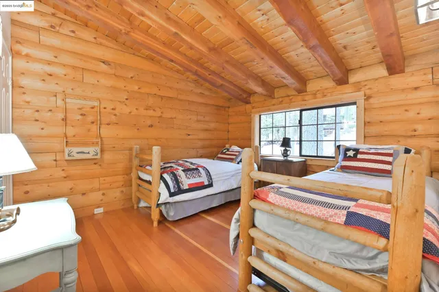 a bedroom with furniture and wooden floor