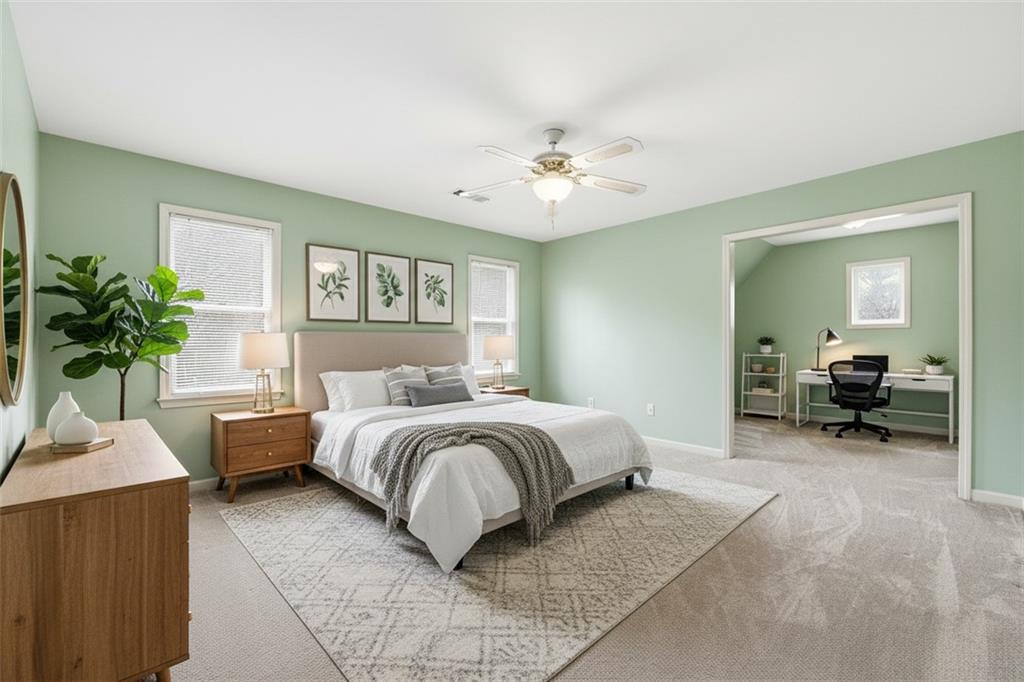 68 Old Mountain Road Northwest Powder Springs, GA 30127 - Photo 13 of 18 a spacious bedroom with a bed a couch and a potted plant