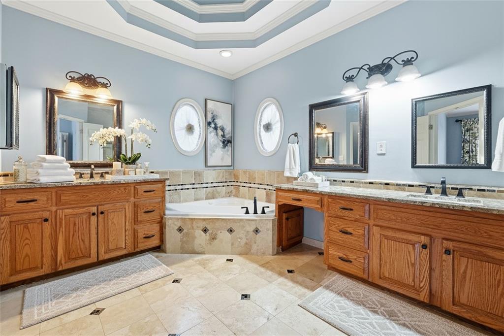 68 Old Mountain Road Northwest Powder Springs, GA 30127 - Photo 10 of 18 a spacious bathroom with a double vanity sink double mirror and a bathtub