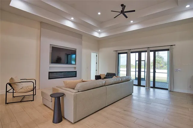 a living room with furniture and a ceiling fan