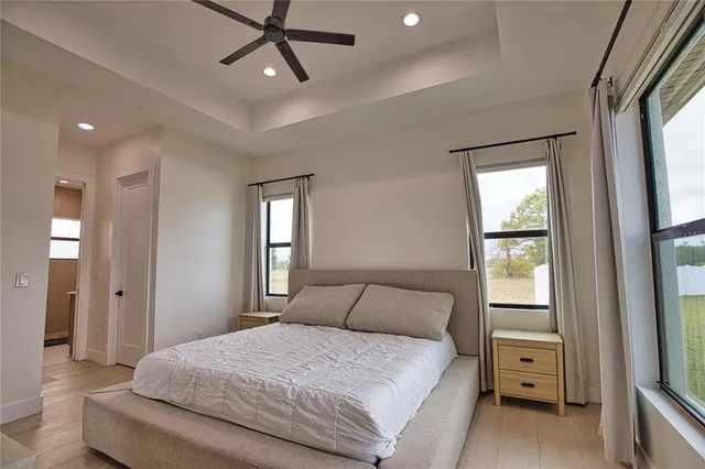 a bedroom with a large bed and a window